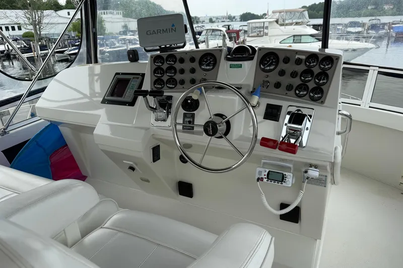 Slide: The Image of 1997 Carver 355 Aft Cabin Motor Yacht helm with Garmin navigation system and control panel. - 9