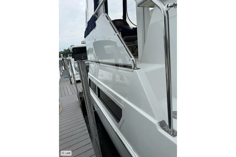 Slide: The Image of Side view of a 1997 Carver 355 Aft Cabin Motor Yacht docked at a marina. - 7