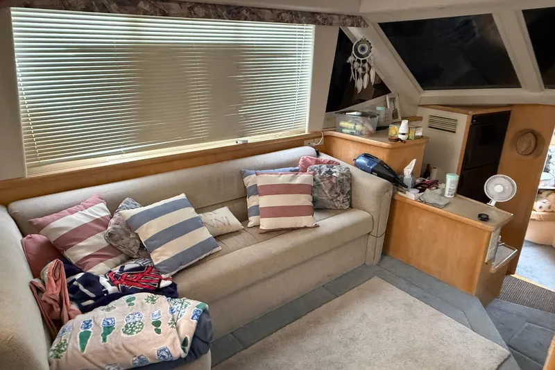 Slide: The Image of Interior of 1997 Carver 355 Aft Cabin Motor Yacht with cozy seating and decorative pillows. - 17