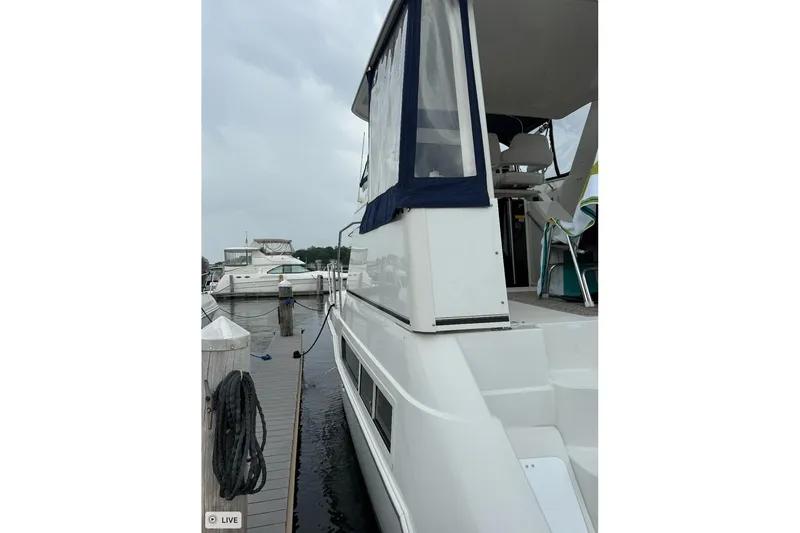 Slide: The Image of 1997 Carver 355 Aft Cabin Motor Yacht docked at marina, side view. - 6