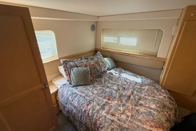 Slide: The Image of Cozy bedroom in 1997 Carver 355 Aft Cabin Motor Yacht with patterned bedding. - 13