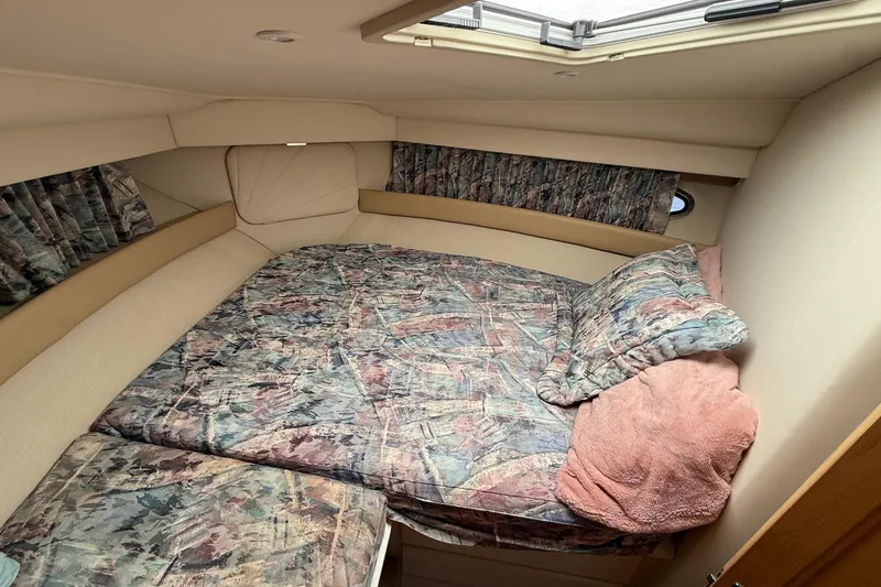 Slide: The Image of Cozy cabin interior of 1997 Carver 355 Aft Cabin Motor Yacht with patterned bedding. - 19