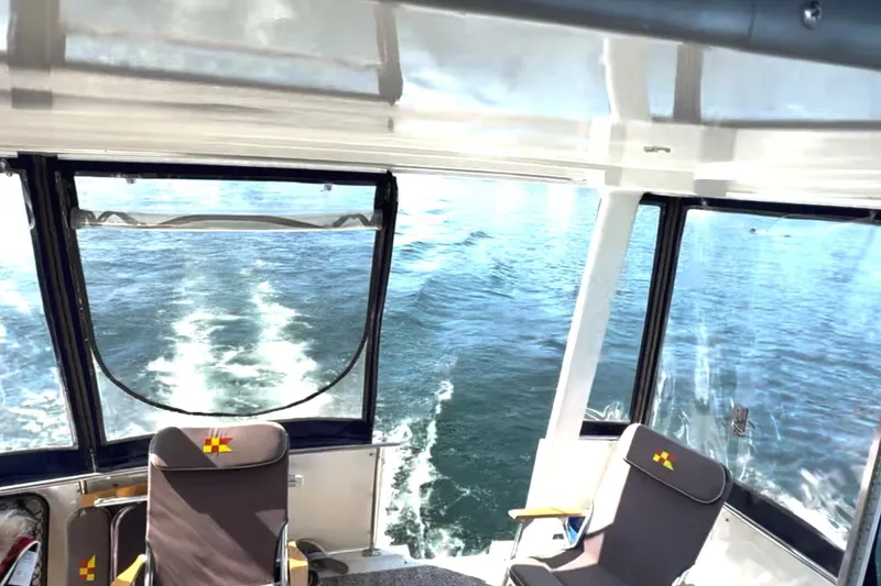 Slide: The Image of 1997 Carver 355 Aft Cabin Motor Yacht interior with ocean view through windows. - 11