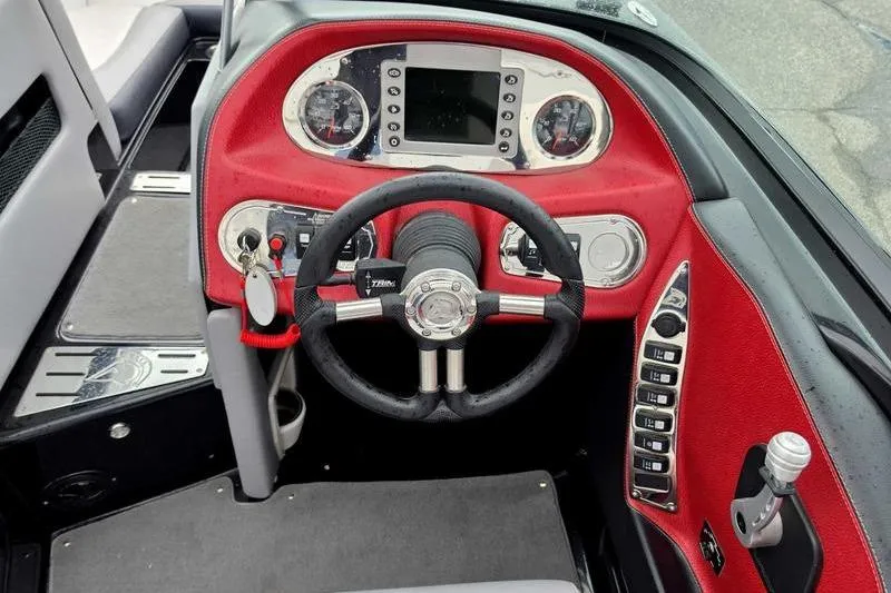 Slide: The Image of Interior dashboard of a 2012 Centurion Enzo SV233 boat with red accents and steering wheel. - 11