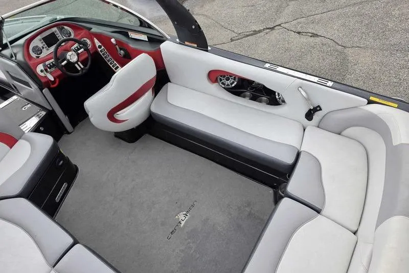 Slide: The Image of Interior of a 2012 Centurion Enzo SV233 boat with red and gray seating. - 13