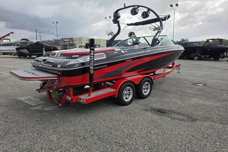 Slide: The Image of 2012 Centurion Enzo SV233 boat on a red trailer in a parking lot. - 6