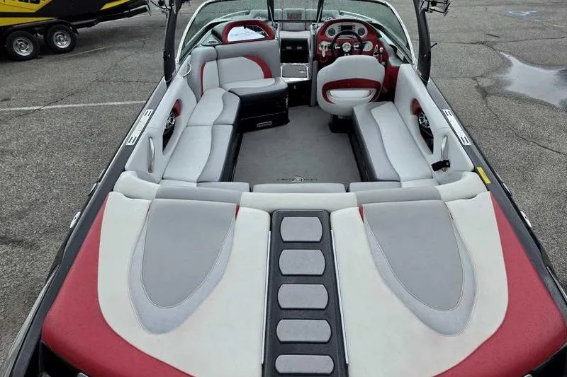 Slide: The Image of 2012 Centurion Enzo SV233 boat interior with red and gray seating, dashboard view. - 8