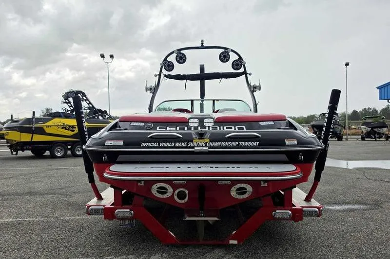 Slide: The Image of 2012 Centurion Enzo SV233 towboat, rear view, parked outdoors, showcasing wake surfing features. - 5
