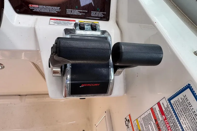 Slide: The Image of Mercury throttle controls on a 2010 Sea Ray Sundancer 310 boat dashboard. - 10