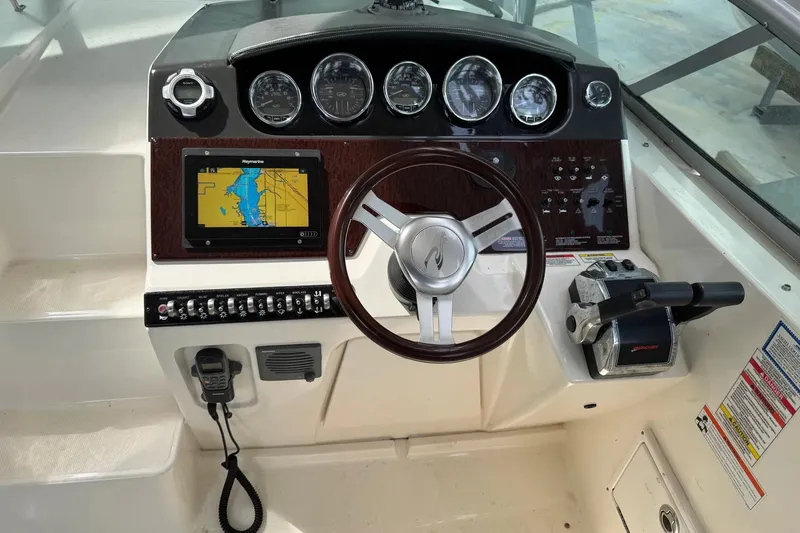 Slide: The Image of Cockpit of 2010 Sea Ray Sundancer 310 with navigation system and controls. - 14