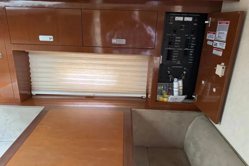 Slide: The Image of Interior of 2010 Sea Ray Sundancer 310 showing control panel and wooden cabinetry. - 25