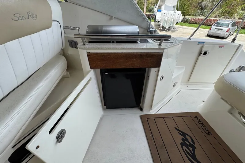 Slide: The Image of Interior of 2010 Sea Ray Sundancer 310 with seating, kitchenette, and storage. - 20