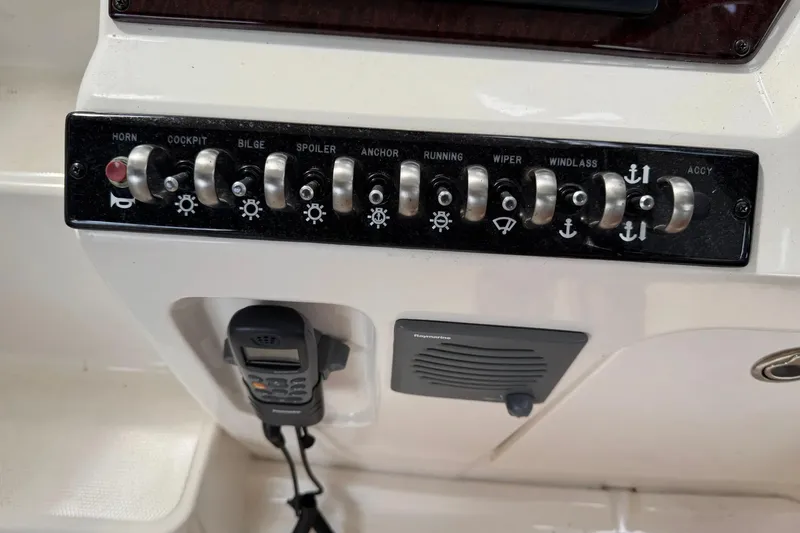 Slide: The Image of Control panel of a 2010 Sea Ray Sundancer 310 boat with labeled switches. - 9