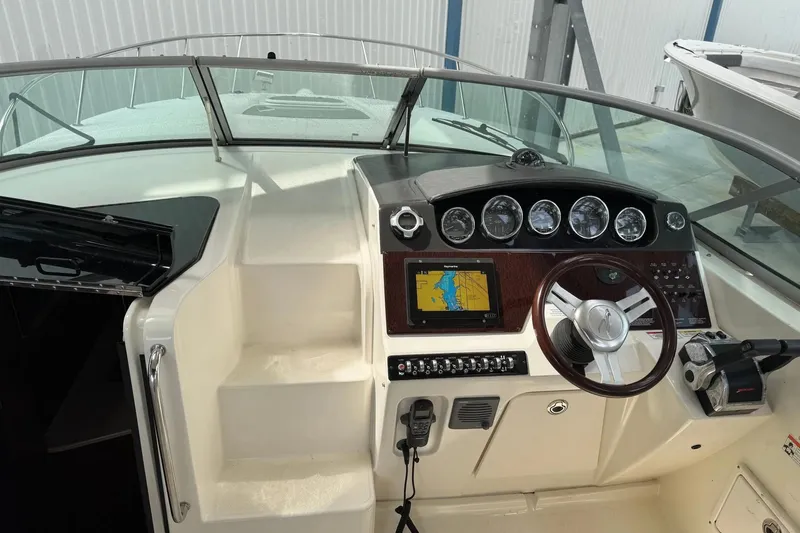 Slide: The Image of Cockpit of 2010 Sea Ray Sundancer 310 with navigation system and steering wheel. - 13