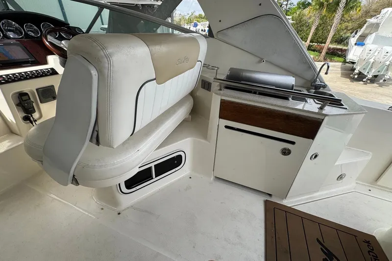 Slide: The Image of Interior of 2010 Sea Ray Sundancer 310 boat with helm seat and kitchenette area. - 21