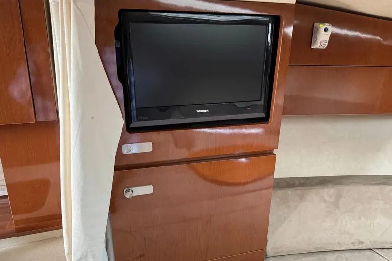 Slide: The Image of Interior of 2010 Sea Ray Sundancer 310 with built-in Toshiba TV and wooden cabinetry. - 36