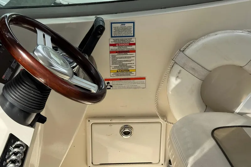 Slide: The Image of Steering wheel and safety equipment on 2010 Sea Ray Sundancer 310 boat. - 16