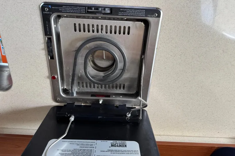 Slide: The Image of Kenyon stove on a 2010 Sea Ray Sundancer 310 boat, showcasing its heating element. - 34