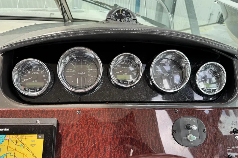 Slide: The Image of Dashboard of a 2010 Sea Ray Sundancer 310 boat with gauges and navigation display. - 5
