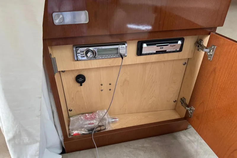 Slide: The Image of An open wooden cabinet with a built-in radio and CD player. - 38
