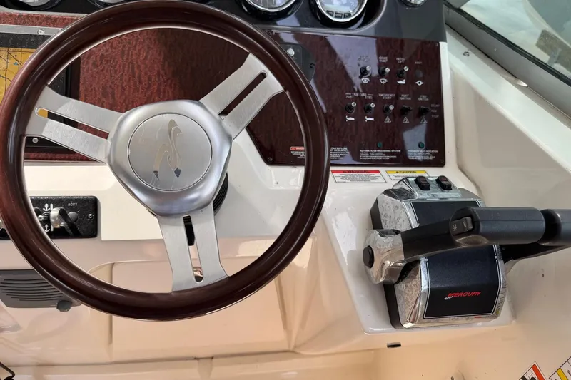 Slide: The Image of Steering wheel and controls of a 2010 Sea Ray Sundancer 310 boat. - 11