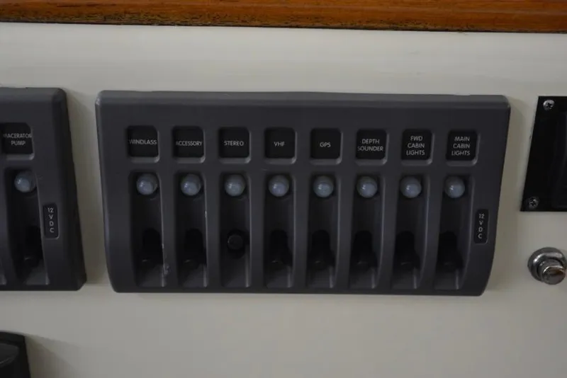 Slide: The Image of Control panel of a 1988 Bunker and Ellis 24 Open boat with labeled switches. - 26