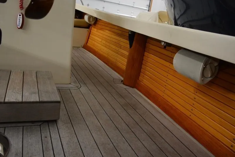 Slide: The Image of 1988 Bunker and Ellis 24 Open boat interior with wooden deck and side paneling. - 13