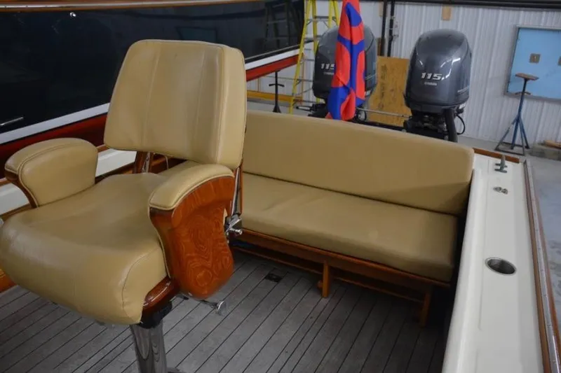 Slide: The Image of 1988 Bunker and Ellis 24 Open boat interior with beige seating and wooden accents. - 16