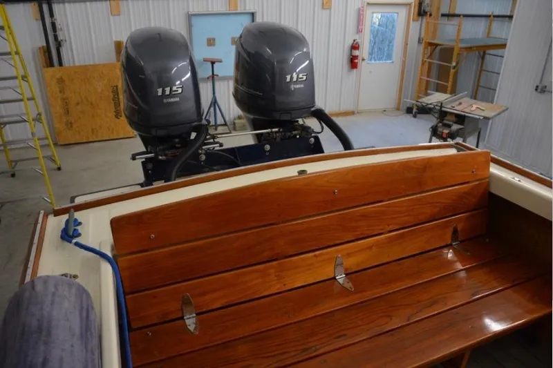 Slide: The Image of 1988 Bunker and Ellis 24 Open boat with dual Yamaha 115 engines in a workshop. - 15