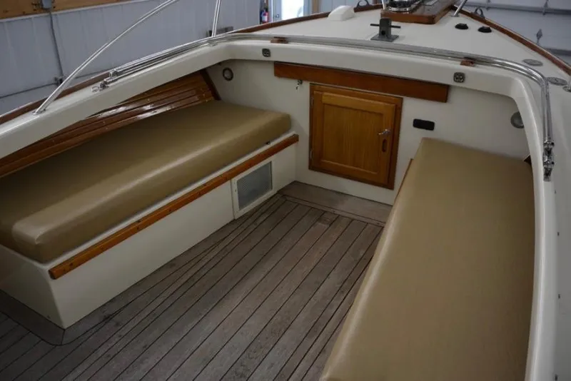 Slide: The Image of Interior of 1988 Bunker and Ellis 24 Open boat with wooden seating and storage. - 28