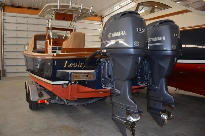 Slide: The Image of 1988 Bunker and Ellis 24 Open boat with twin Yamaha 115 engines in a garage. - 9