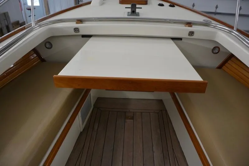 Slide: The Image of 1988 Bunker and Ellis 24 Open boat interior with wooden accents and seating area. - 32
