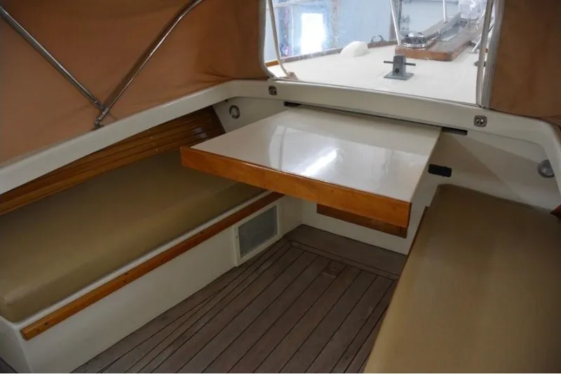 Slide: The Image of Interior of 1988 Bunker and Ellis 24 Open boat with seating and table. - 30