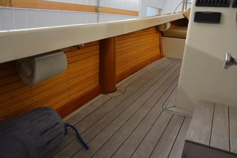 Slide: The Image of Interior of 1988 Bunker and Ellis 24 Open boat with wooden paneling and seating. - 12