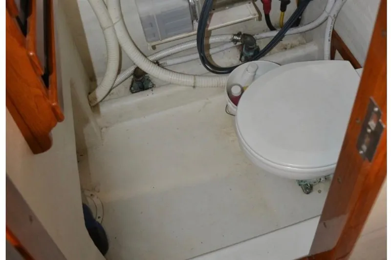 Slide: The Image of 1988 Bunker and Ellis 24 Open boat bathroom with toilet and plumbing. - 27