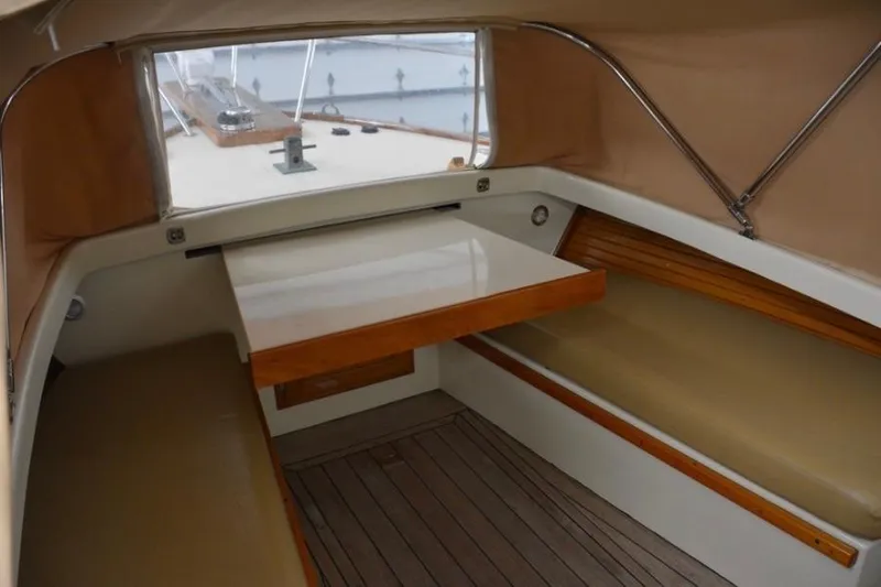 Slide: The Image of Interior of 1988 Bunker and Ellis 24 Open boat with seating and table. - 31