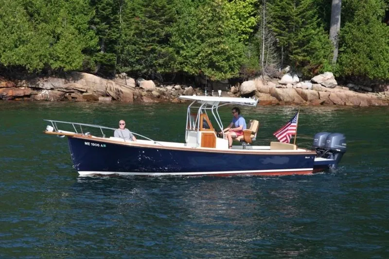 Slide: The Image of 1988 Bunker and Ellis 24 Open boat cruising on a scenic lake with lush forest backdrop. - 5