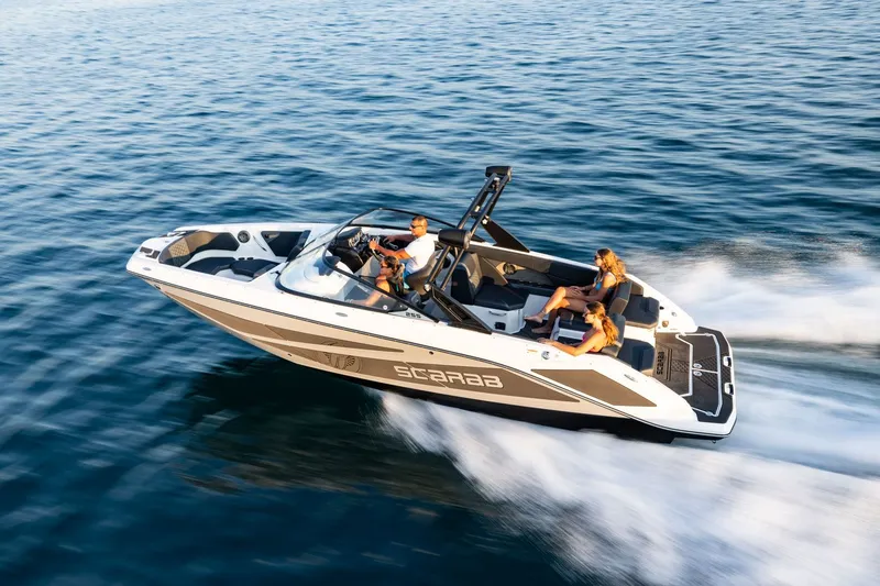 Slide: The Image of 2026 Scarab 255 LX speeding on the water with several people on board. - 16