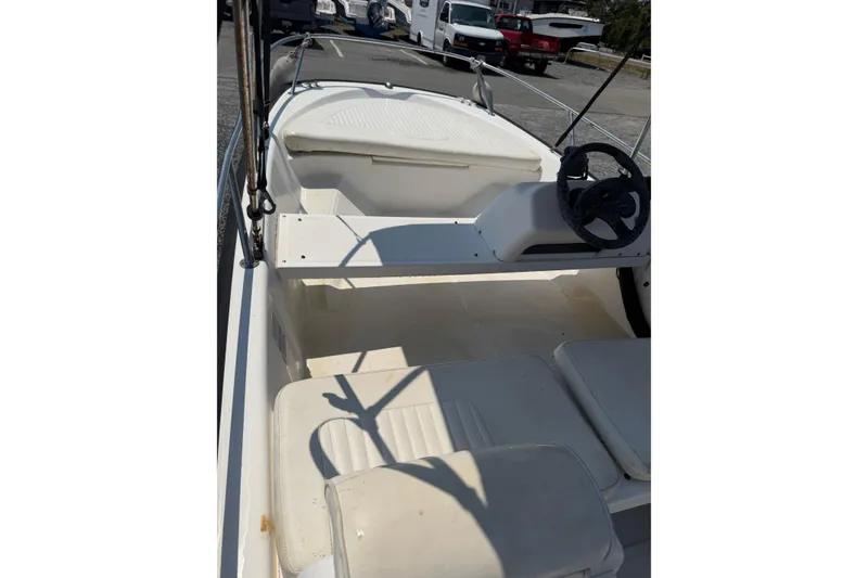 Slide: The Image of 2003 Boston Whaler 130 Super Sport interior with steering wheel and seating. - 6