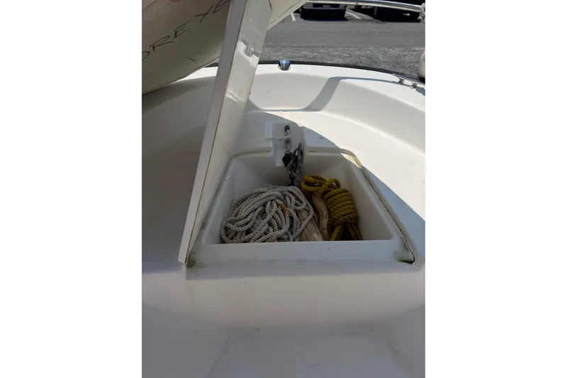 Slide: The Image of Open storage compartment on 2003 Boston Whaler 130 Super Sport with ropes inside. - 4