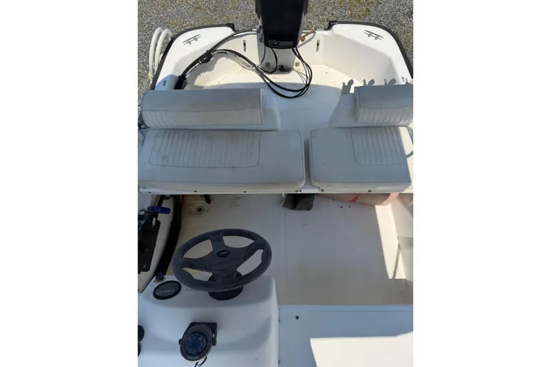 Slide: The Image of Interior view of a 2003 Boston Whaler 130 Super Sport with two seats and a steering wheel. - 7