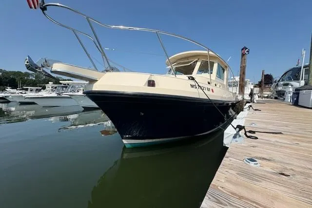 Slide: The Image of 2003 Albin 28 Tournament Express docked at a marina under clear blue skies. - 8
