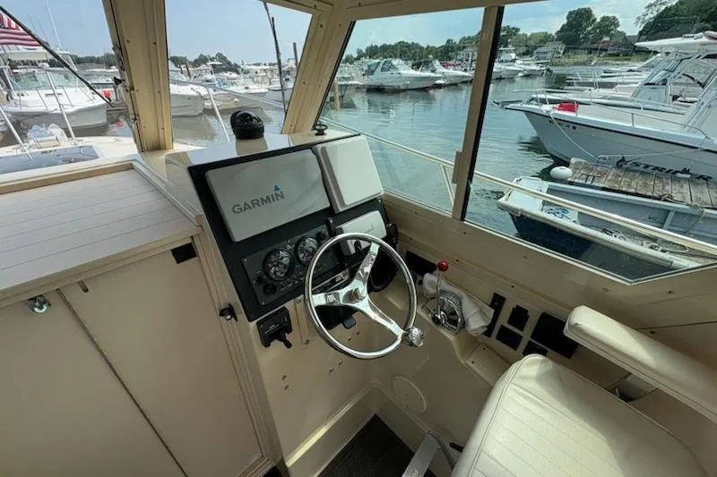 Slide: The Image of 2003 Albin 28 Tournament Express helm with Garmin navigation, docked at a marina. - 27