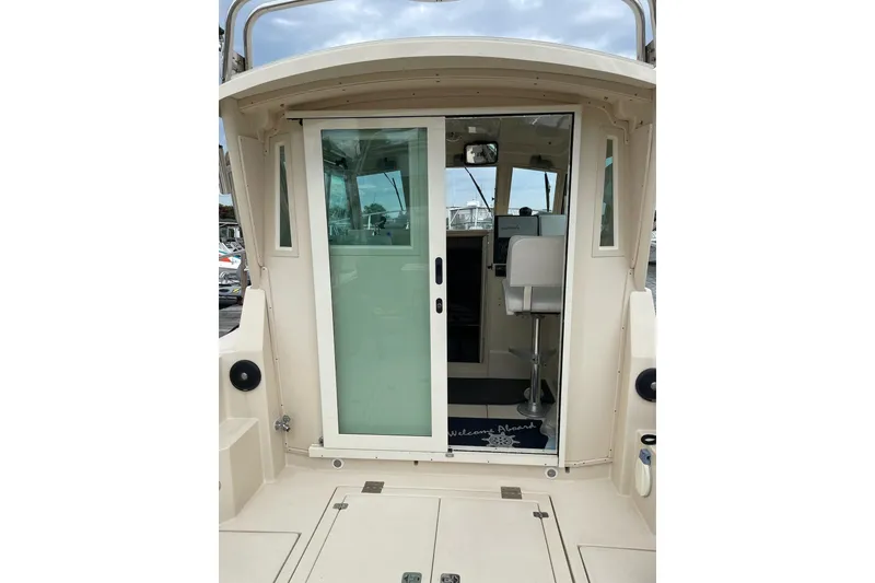 Slide: The Image of 2003 Albin 28 Tournament Express boat with sliding glass door and interior view. - 11
