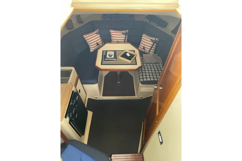 Slide: The Image of Interior of 2003 Albin 28 Tournament Express with cozy seating and nautical decor. - 12