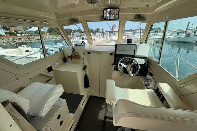 Slide: The Image of Interior view of 2003 Albin 28 Tournament Express boat cockpit with steering wheel and navigation equipment. - 25