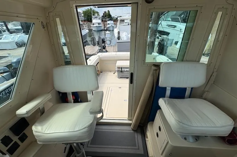 Slide: The Image of Interior view of a 2003 Albin 28 Tournament Express boat with white seating. - 26