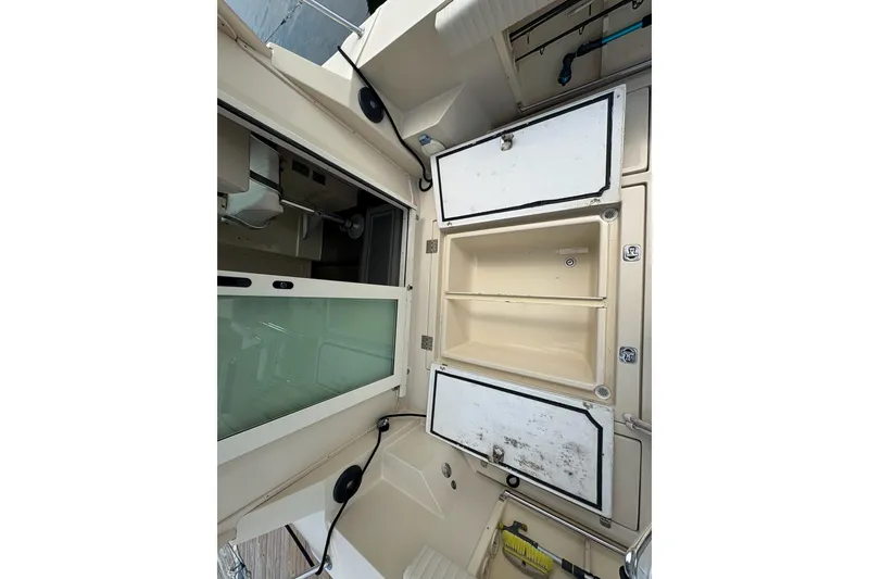 Slide: The Image of Interior view of a 2003 Albin 28 Tournament Express boat, featuring storage compartments. - 19