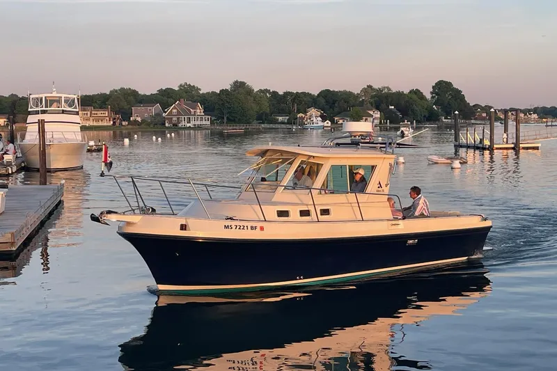 The Image of 2003 Albin 28 Tournament Express boat cruising in a serene harbor at sunset. - 0
