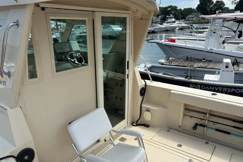 Slide: The Image of 2003 Albin 28 Tournament Express boat interior with docked vessels in the background. - 29